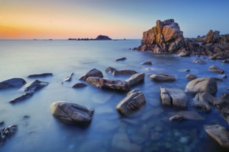 Distinctive orange rock formations in the evening light, on the English Channel coast on the Rosa