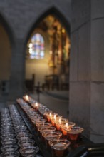 Burning candles in Radolfzell MÃ¼nster, which create a peaceful and spiritual atmosphere,