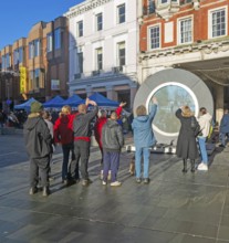 People on the Cornhill in the town centre view the first ever UK Portal in Ipswich, Suffolk,