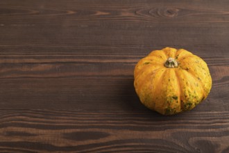 Orange Pumpkin on brown wooden background. Side view, copy space. healthy food, vegetable,