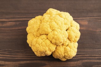 Yellow Cauliflower on brown wooden background. Side view, close up. healthy food, vegetable,