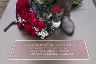 Red roses with a mourning ribbon lie on the Walter LÃ¼bcke memorial during the erection of Walter
