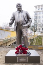 Walter LÃ¼bcke memorial with red roses and a mourning ribbon at the erection of Walter LÃ¼bcke