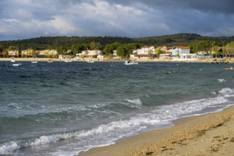 View of coast with soft waves, houses and cloudy sky, beach near GÃ¼zelyali, GÃ¼zelyalÄ±,