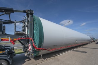 Overlong heavy-duty transporter with a part of a wind turbine, at a motorway rest area of the A9,
