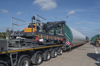 Heavy-duty transporter with a part of a wind turbine, at a motorway rest area of the A9,