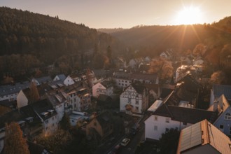 Picture of a village in a soft evening mood surrounded by hills and setting sun, Dillweisenstein,