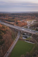 Junction of roads surrounded by forests, at dusk, showing rural transport infrastructure, A8