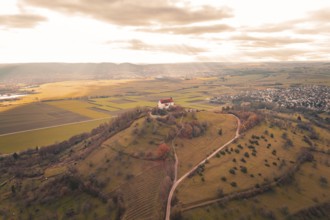 Church on hill with wide views of fields and villages under cloudy sky, Wurmlinger Chapel,