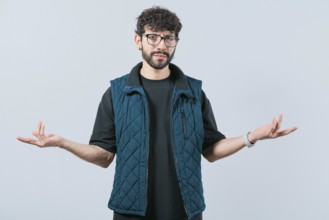 Confused man spreading hands bewildered isolated. Unsure person with face worried