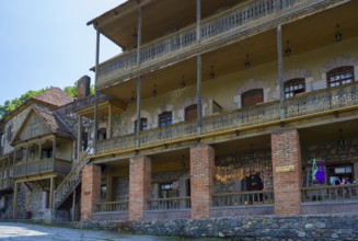 Large historic building with brick and wooden verandas, rustic charm, Old Town, Sharambeyan Street,