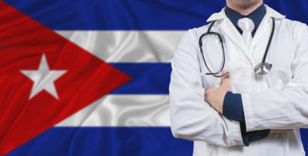 Male doctor with stethoscope on Cuba flag. Doctor holding stethoscope on Cuba flag