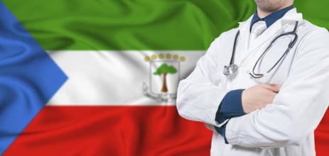 Equatorial Guinea healthcare concept. Male doctor on Equatorial Guinea flag. Doctor with crossed