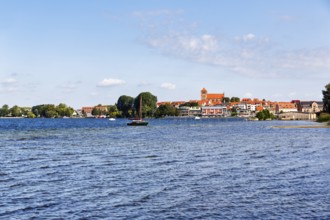 Shore of Lake MÃ¼ritz, city harbor with St. George Church, sailboat, Waren an der MÃ¼ritz,