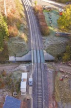Aerial view of tracks at a railroad crossing with surrounding vegetation, Hermann Hesse Railway bat