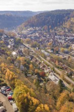 Aerial view of a town in an autumn landscape surrounded by hills, Hermann Hesse Railway Bat Tunnel