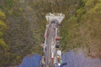 Aerial view of a railway tunnel construction site surrounded by trees, Hermann Hesse Railway bat