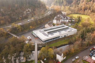 Hilly area with a building with solar systems in a village, PV at Walther Lindner Sporthalle Calw,