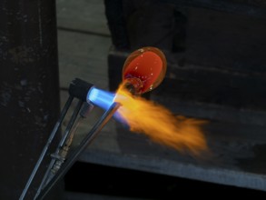 Glassblowers at work, molten glass and flames, Bohemia, Czech Republic