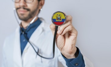 Doctor holding stethoscope with Ecuador flag. Ecuador health and care concept. Ecuador flag on