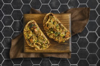 Two sandwiches with flavorful mix of honey mushrooms, enoki mushrooms, champignon, and leeks.