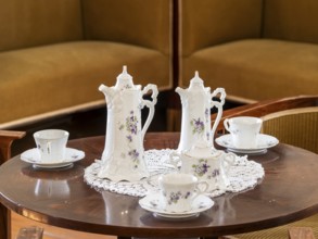 Vintage coffee service on the table, old porcelain