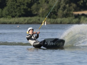 Young man with wakeboard, sporty on water, athletic model, active water sports, wake park