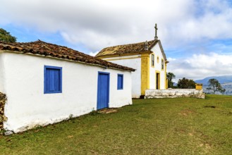 Small, old colonial-style chapel with an attached house in Minas Gerais, Minas Gerais, Brazil