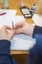 Circle holding hands while working on a notebook, Jugend Forschungszentrum Nagold, Calw district,