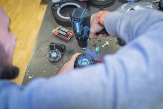 Person using drills on a component on a table, Jugend Forschungszentrum Nagold, Calw district,