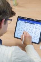 Person taking handwritten notes on a tablet, Jugend Forschungszentrum Nagold, Calw district,