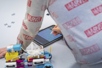 Child uses a tablet to control or design a robot, Jugend Forschungszentrum Nagold, Calw district,