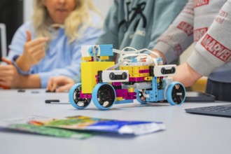 Children assemble a colorful robot on a table, Jugend Forschungszentrum Nagold, Calw district,