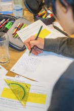 Person writes notes on paper using multiple tools, Jugend Forschungszentrum Nagold, Calw district,
