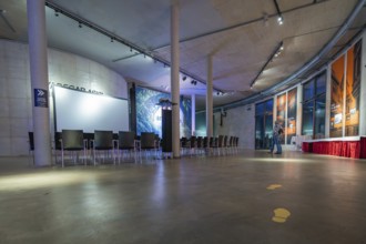 A modern gallery space with chairs and atmospheric lighting, Amazonia exhibition, Gasometer,