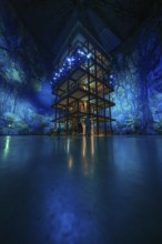 Tall structure with fascinating light installation in a blue room, Amazonia exhibition, Gasometer,