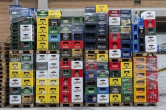 Empty beverage crates, from various manufacturers, bottling, types, stacked at a restaurant, for