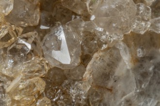 Bright, square crystals are visible on a piece of rock. The light underlines their structure and