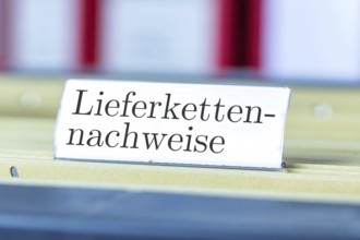 (photo montage) Sign with the inscription SUPPLY CHAIN EVIDENCE on a hanging file register