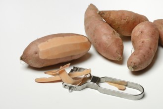 Sweet potato with potato peeler, Ipomoea batatas