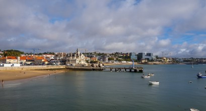 View of the old town and a small stretch of beach by the sea, Cascais, Portugal