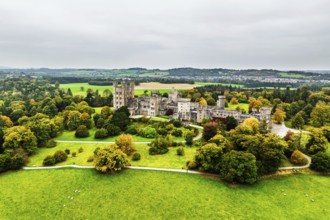 Autumn colours over Penrhyn Castle and Garden from a drone, Llandygai, Bangor, Gwynedd, North