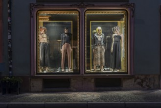 Fashion shop in evening mood with illuminated shop window