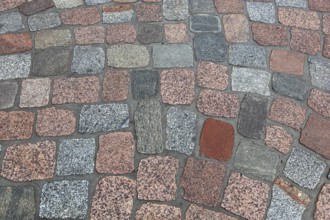 Geometric pattern of dry paving stones in warm colors