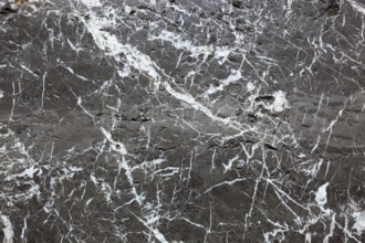 Black marble surface with white veins, exudes elegance and luxury