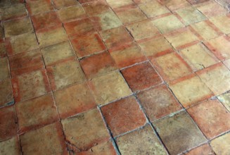 Terracotta tiles in warm shades of red with a rustic atmosphere