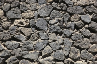 Dense arrangement of gray lava stones in natural formation