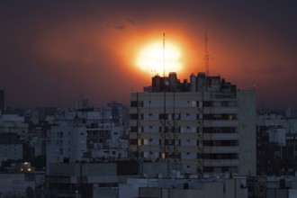Dramatic sunset over a big city, symbol of climate change and threat to poor countries, Buenos