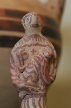 Female ceramic figure caring for a baby or toddler, 1500 century BC Archaeological Museum, Nemea,