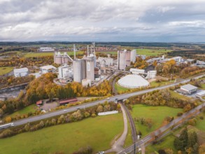 Large factory complex in an autumn setting, photographed from above